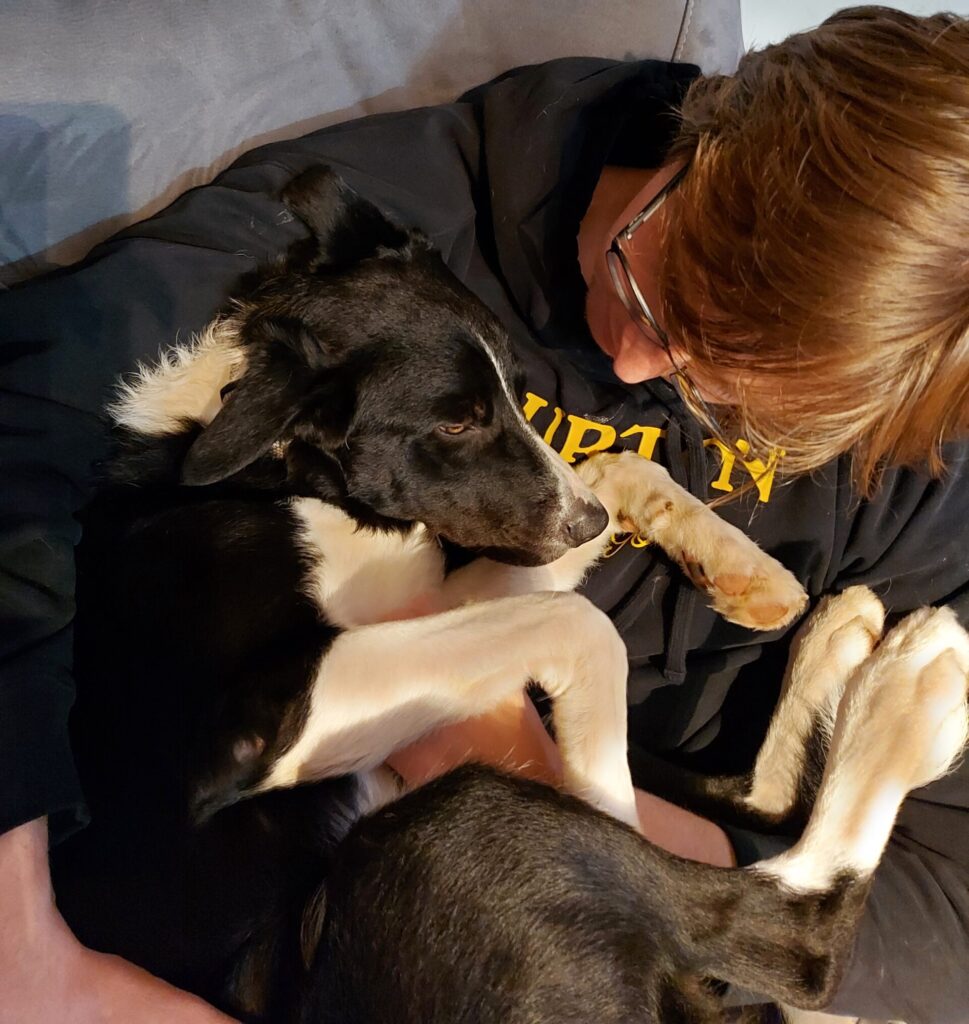 Spencer and Atlas Douglas cuddling on the couch. This is what every dog deserves to have in their life.